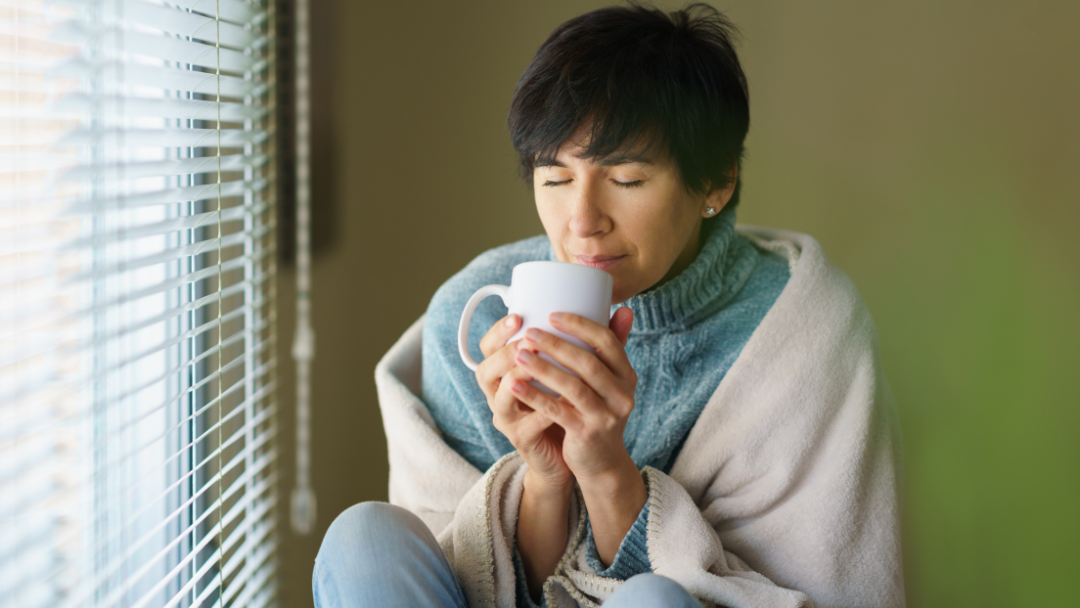 a woman smelling coffee