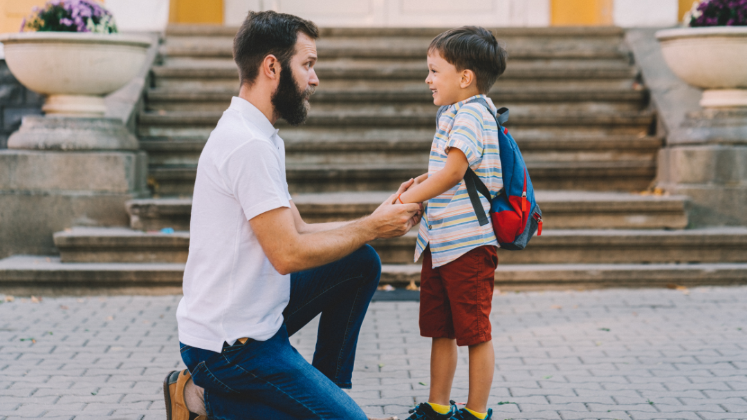 Father and young son holding hands