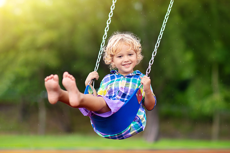 Fetal Alcohol Syndrome and play therapy. Boy on swing.